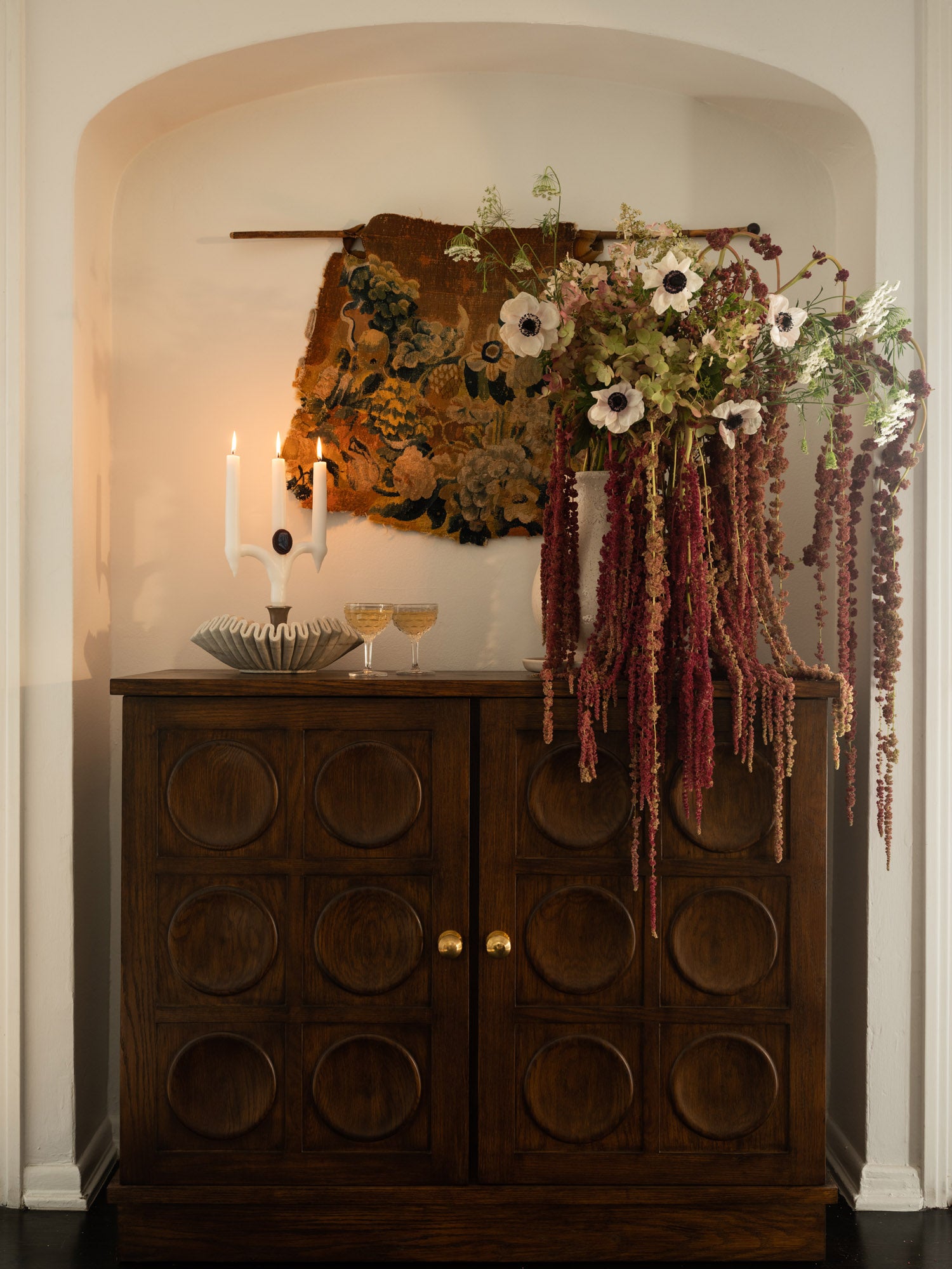 Bar cabinet with candles, champagne, and flowers
