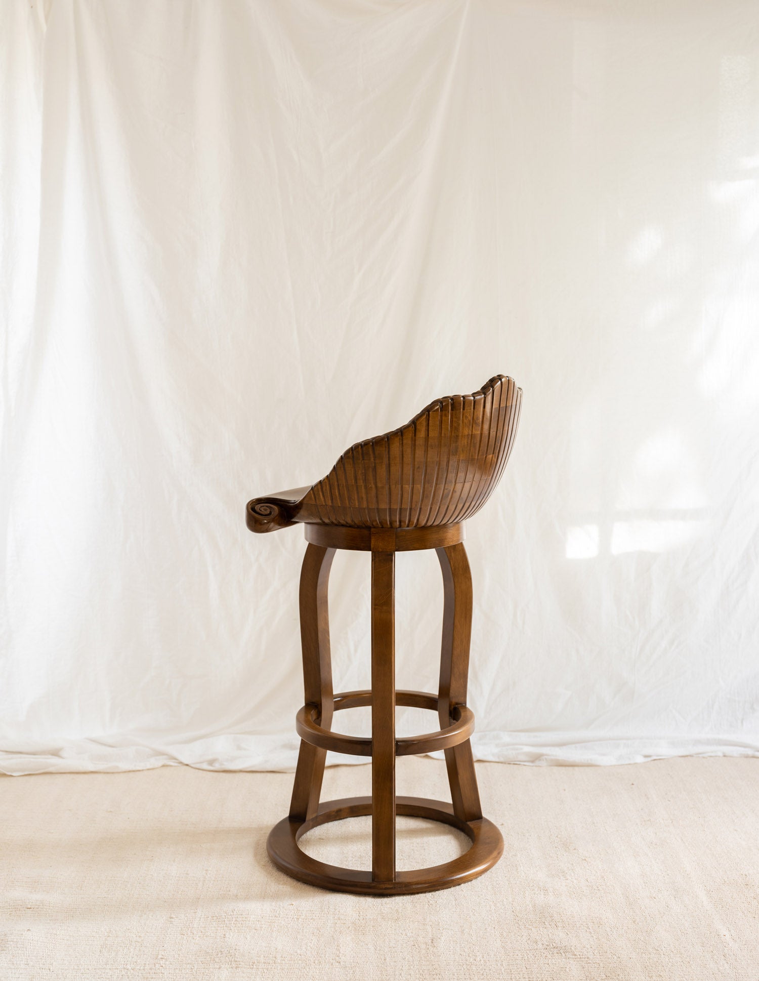Back of stool shaped like a shell